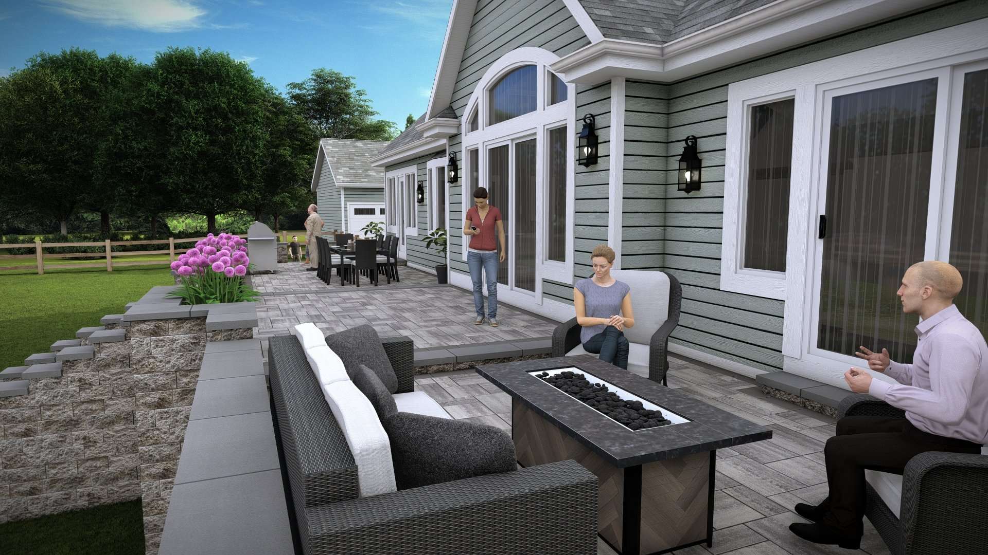 Outdoor living space featuring a modern patio with seating, fire table, and dining area, surrounded by lush greenery and flowering plants, illustrating hardscape design by Laughter Family Hardscapes.