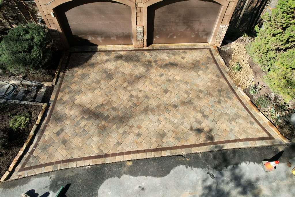 Paver patio installation showcasing durable stonework, enhancing outdoor living space and complementing hardscape design elements.