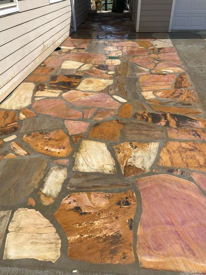 Custom flagstone walkway with earthy tones and a smooth finish, highlighting expert masonry services in Etowah, NC, for durable and aesthetic outdoor spaces.